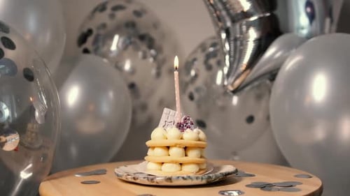 Delicious Birthday Cake with Candle and Balloons