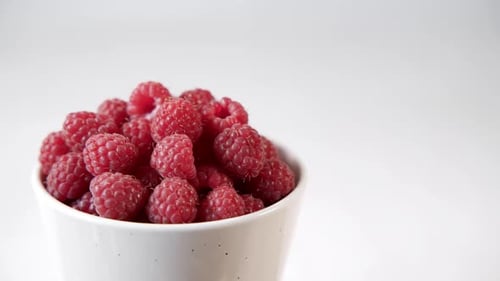 Ripe Raspberries in a White Rotating Cup