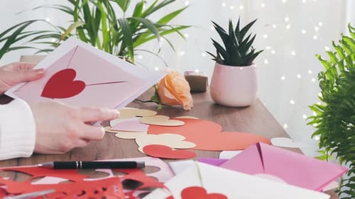 Woman Crafting Handmade Valentine's Day Cards at Home