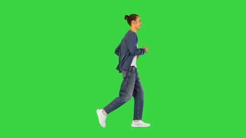 Young White Man Runs Smiling on a Green Screen Chroma Key