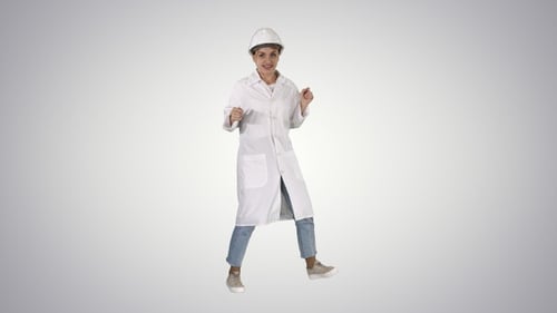 Engineer woman dancing in funny way on gradient background