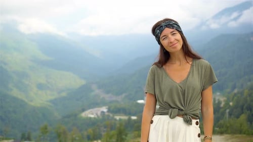 Woman Smiles in Front of Mountain Vista