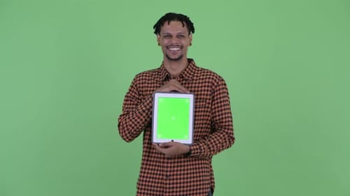 Young Adult Presenting Tablet with Chroma Key Screen