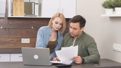 Young Couple Reviewing Finances Together at Home