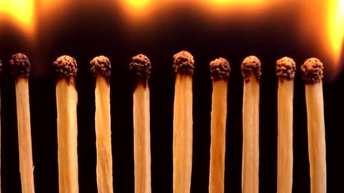 Matches Burning Down in Macro on Black Background