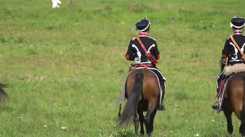 Military Cavalry Ride Horses Across Green Field