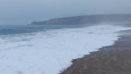 Amazing Waves with White Foam Roll on Clean Sand Upper View
