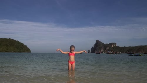 Girl Playing In Water At The Beach