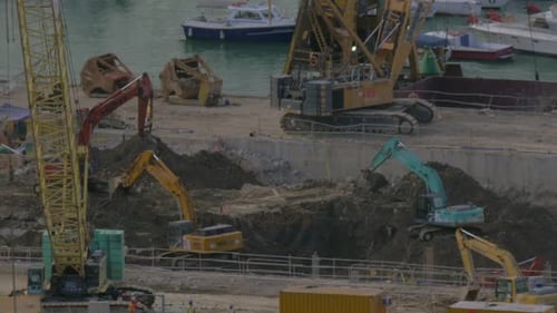 View of Excavators Digging a Hole Near Dock. Hong Kong, China
