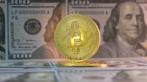 Gold Bitcoin Coins on US Dollar Currency
