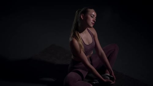 High Angle View Portrait of Confident Slim Woman Stretching Neck Muscles Sitting in Asana on