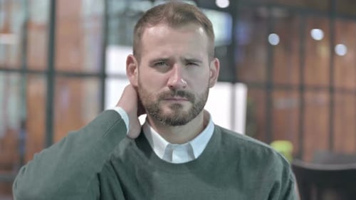 Man Massaging Neck to Relieve Pain