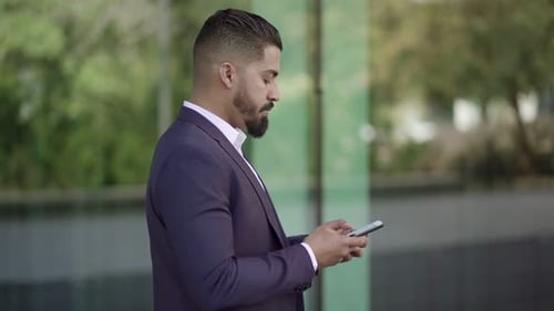 Side View of Businessman Messaging By Smartphone