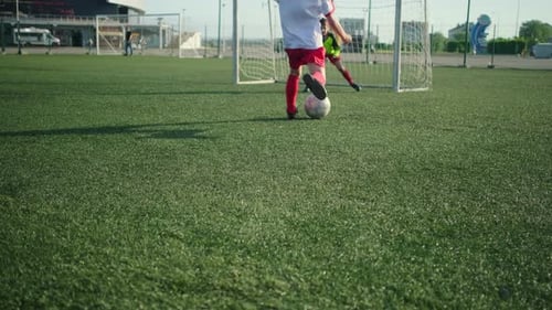 Young Boy Goalkeeper Catches Ball During Training