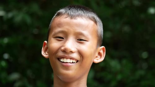 Close up face boy laugh hearing a joke