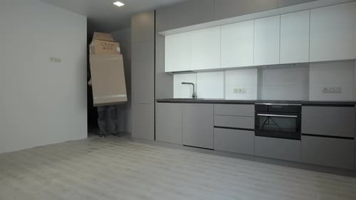 Man Delivering Boxes to Modern Kitchen