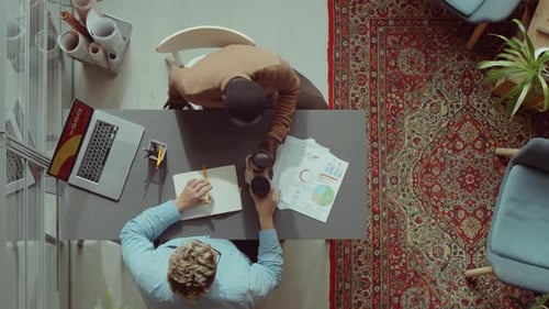 Multiethnic Colleagues Having Coffee and Working Together in Office