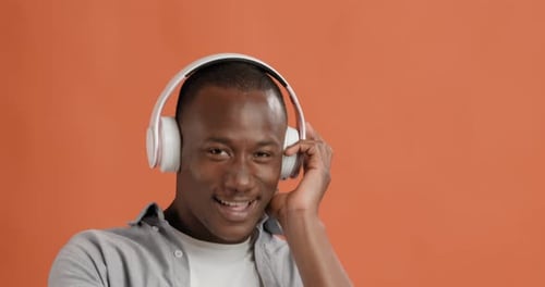 Smiling Man Listening to Music With Headphones