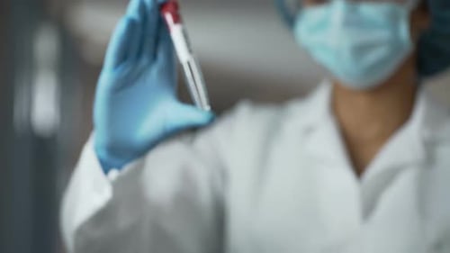Scientist Holds Ebola Virus Test Tube