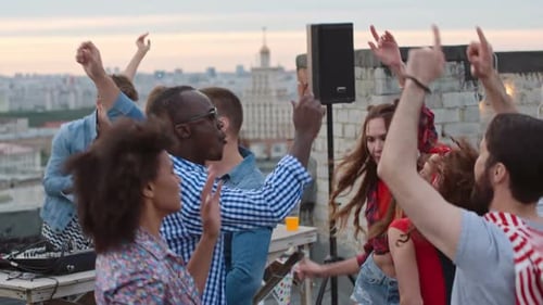 Young Adults Dancing at Lively Rooftop Party