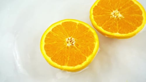 Juicy Orange Halves on White Background