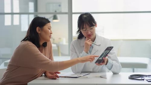 Doctor Explains X-Ray to Patient in Medical Office