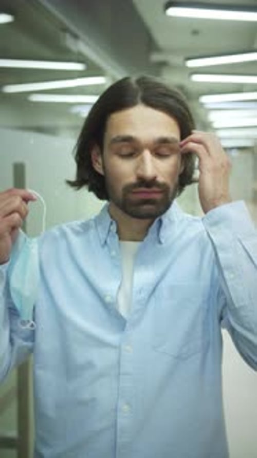 Man Removes Surgical Mask and Smiles