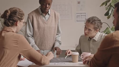 Team of Designers Working with Blueprints in Office