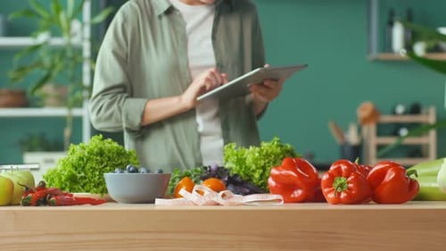 Woman Prepares Healthy Meal Using Tablet Recipe