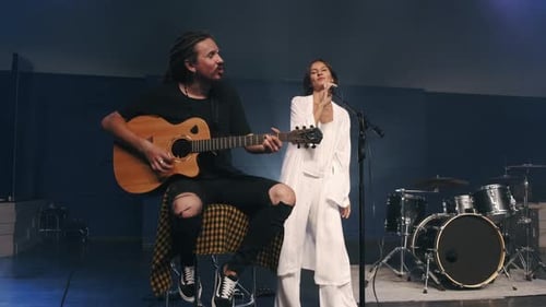 Musicians Perform Music on Stage with Guitar