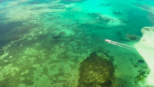 Seascape Coral Reef and Blue Sea with Motorboat