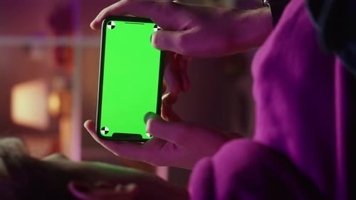 Vertical Video of Man Using Smartphone with Chroma Key in Evening