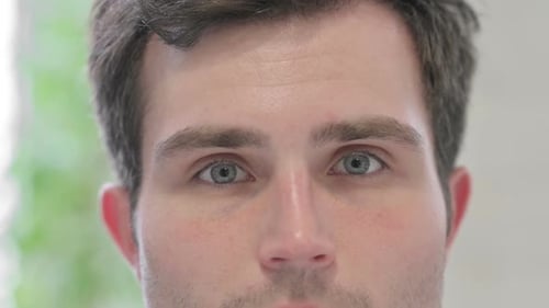Close Up of Blinking Eyes of Man Looking at the Camera