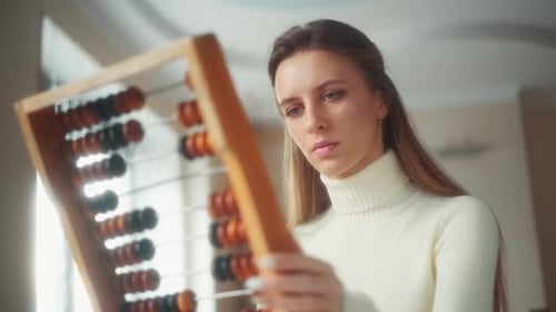 Woman Works With Abacus Counting Frame Indoors