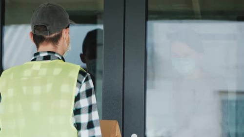 A Woman Receives Ordered Food To Her Home During the Quarantine Period