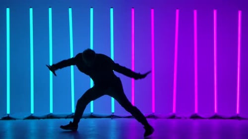Breakdancing Acrobatic Elements Performed By a Professional Dancer Against the Backdrop of Bright