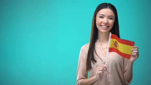 Smiling Young Woman Holding Spanish Flag