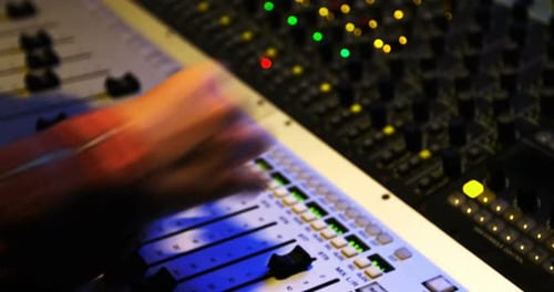 Female audio engineer using sound mixer