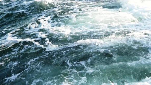 Close up of rock beaches. Wave breaking on the rocks in the sea