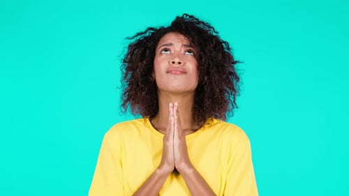 Young Woman Praying with Hopeful Expression
