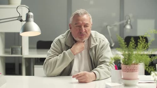 Adult Man Coughing at Office Desk