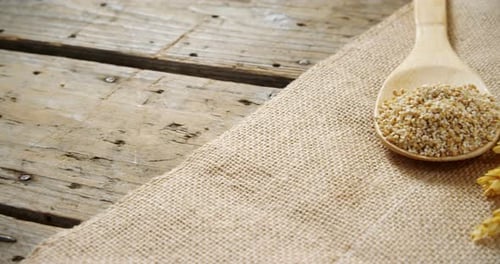 Spoon Full of Grains with Wheat on Burlap