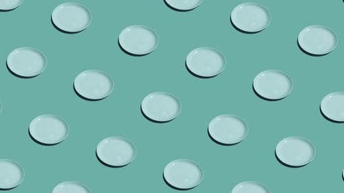 Light Blue Plates Arranged in Neat Repeating Pattern