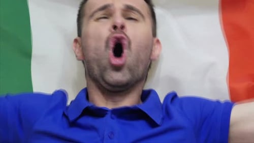 Man Shouting with Arms Wide and Flag