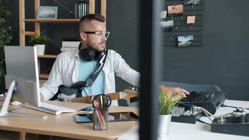 Man Composing Music in Home Recording Studio