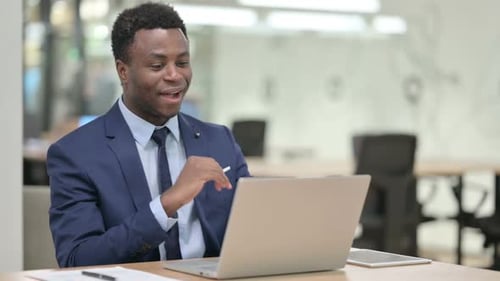 Cheerful Young Adult Video Conferencing in Office