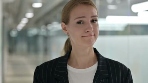 Businesswoman in Pinstripe Suit Looking Confidently at Camera