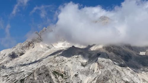 Mountain Peak with Clouds Against Blue Sky