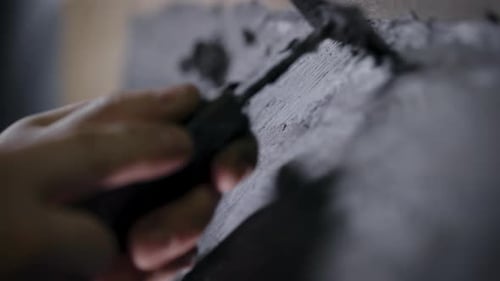 A Close-up of a Man's Hand with a Tool. A Professional Removes the Form From the Clay with the Help