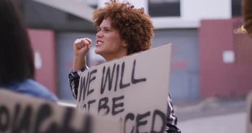 Activist Protesting in City With Raised Fist